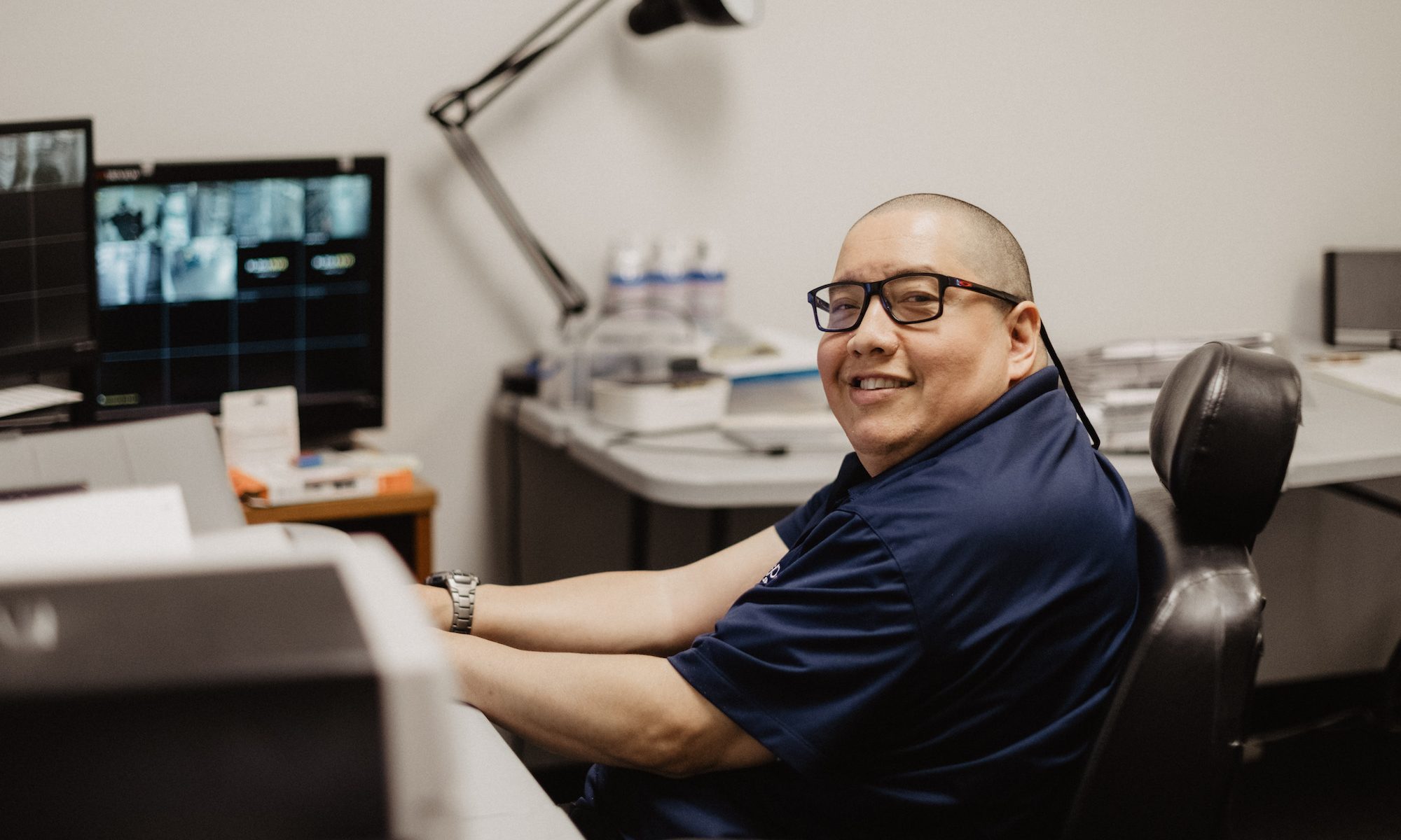 A man smiling at his office