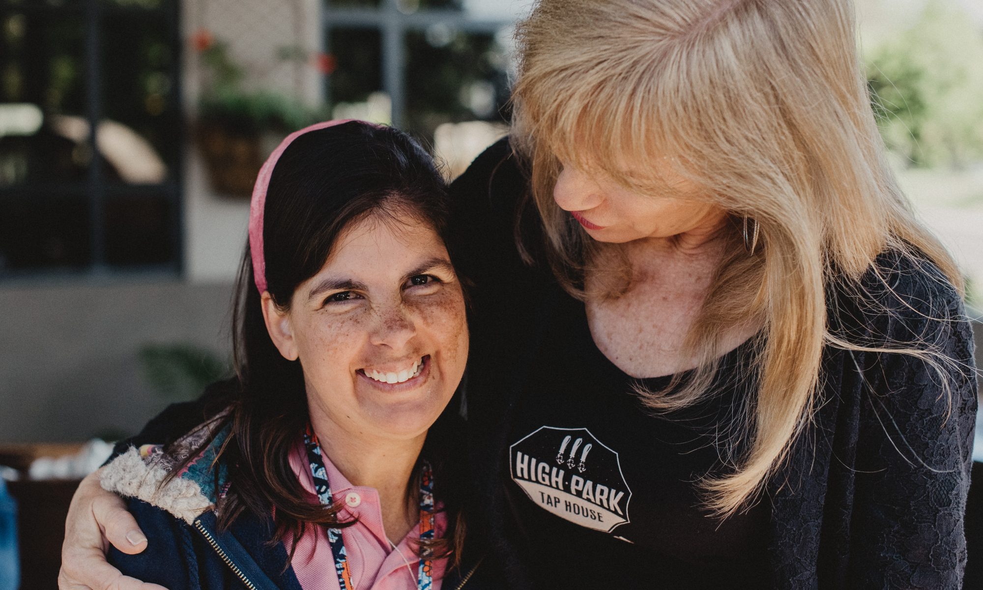 Two ladies hugging at Goodwill of Orange County