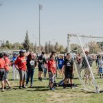 Special Games participants standing on grass next to soccer net