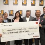 Goodwill representatives holding a $50,000 grant from Wells Fargo