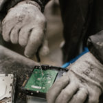 Hands working on circuitboard.
