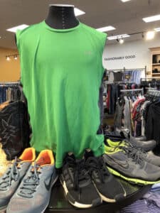 Mannequin with green vest displayed inside Goodwill Store & Donation Center