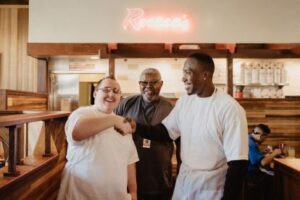 Aatif shaking hands with Roscoe's House of Chicken and Waffles