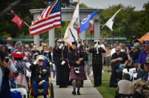 People with US flags walking through the crowd on Memorial day