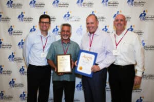 Four people pose at Employment Community Partner Award event