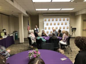 A lady's speech at Goodwill of Orange County and a group of people listening