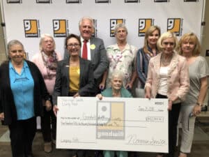 Janet Van Emon and Goodwill staff holding a $450,000 cheque