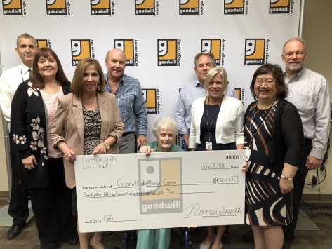 Janet Van Emon and Goodwill staff holding 0,000 check