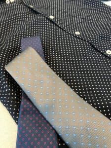 Close up image of blue polka dot men's shirt and tie