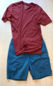 Solid blue shorts with a simple red V-neck or crew t-shirt.