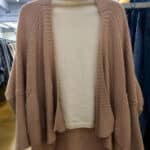 White long-sleeved turtleneck with a brown loose-fitting cardigan