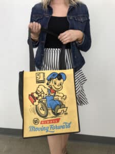 A women holding Goodwill of Orange County reusable bag in her hand