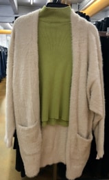 Long-sleeved turtleneck green top with a loose-fitting cardigan