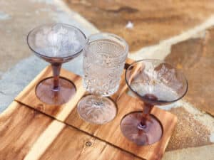 Three mini glasses on a wooden board