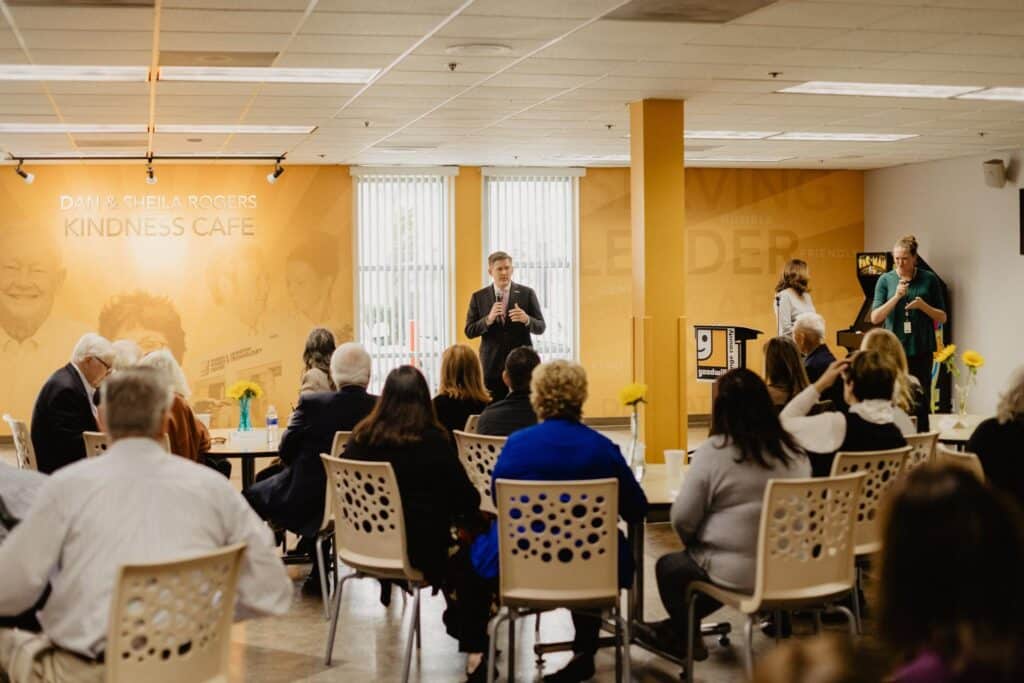 A man delivering his speech at Dan and Sheila Rogers Kindness Cafe