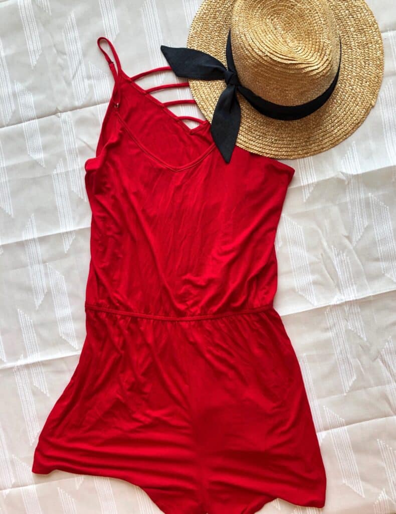 Bright red romper and straw hat with navy blue detailing