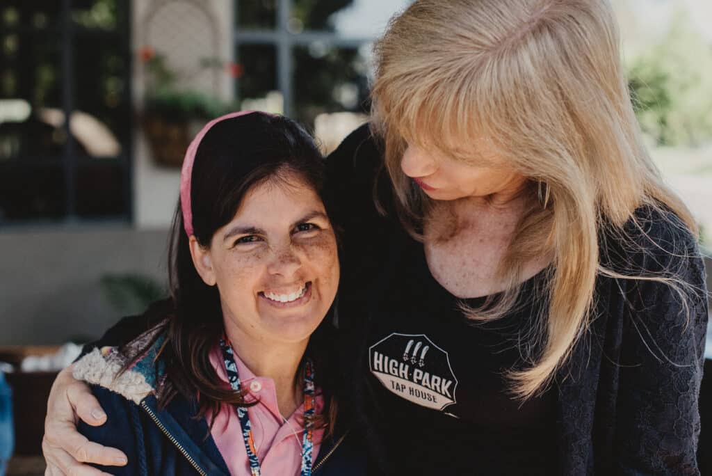 Two ladies hugging at Goodwill of Orange County