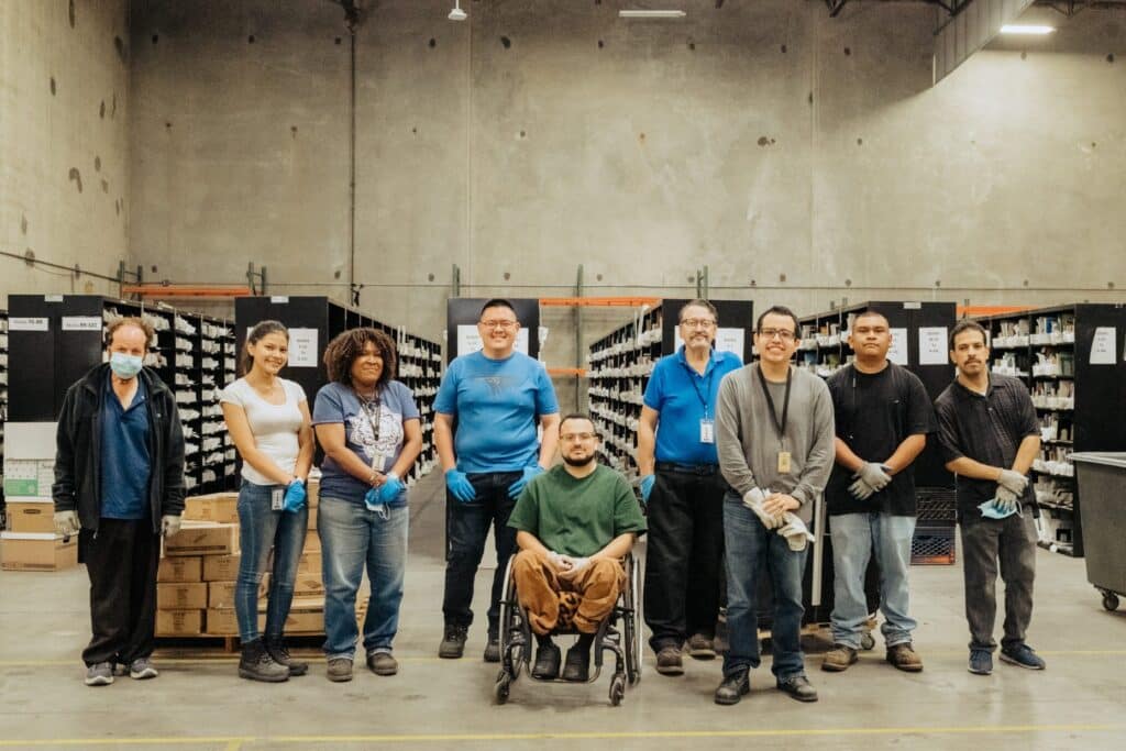 People smiling and posing for a photo at work place