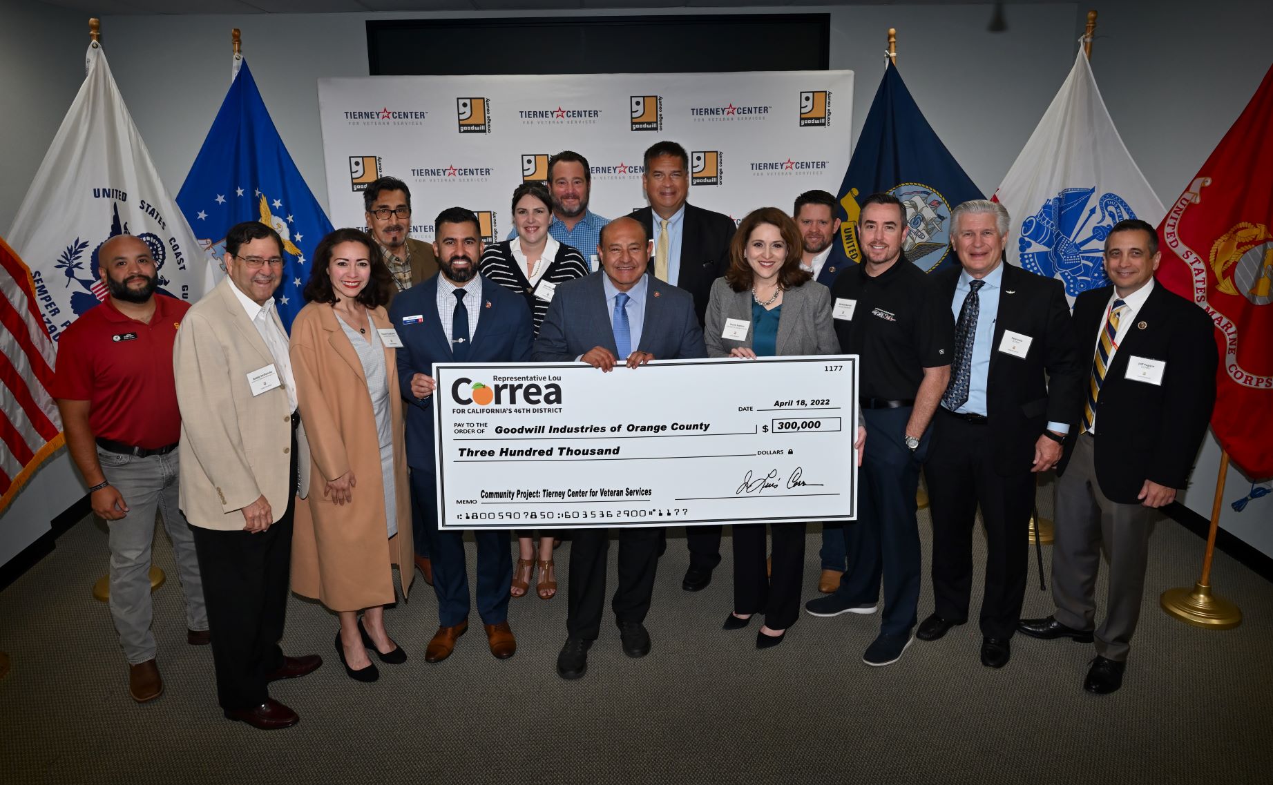 People posing for photo during check presentation at Tierney Center