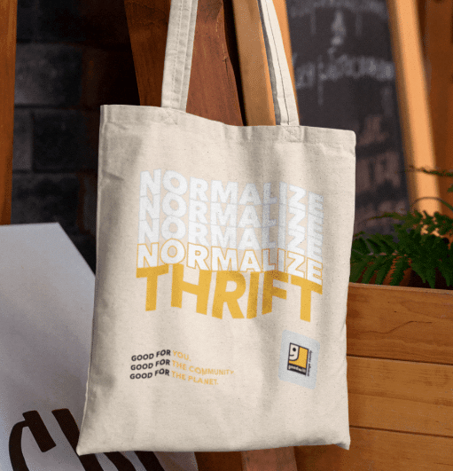 Shopping bag printed with OC goodwill logo and text "Normalize thrift".