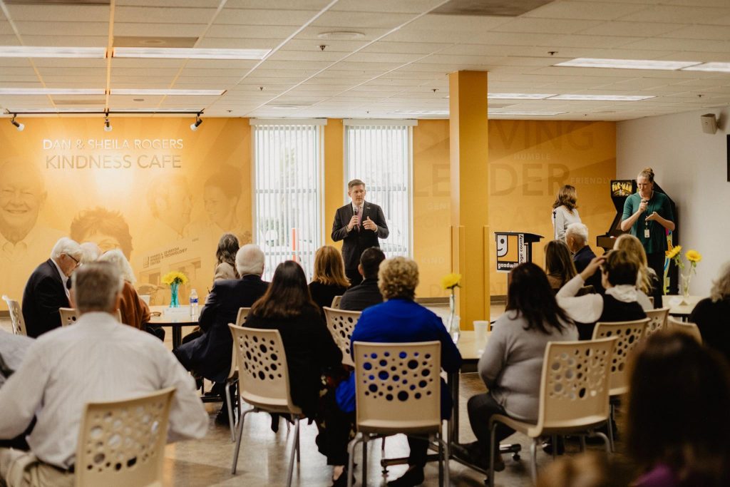 A man delivering his speech at Dan and Sheila Rogers Kindness Cafe