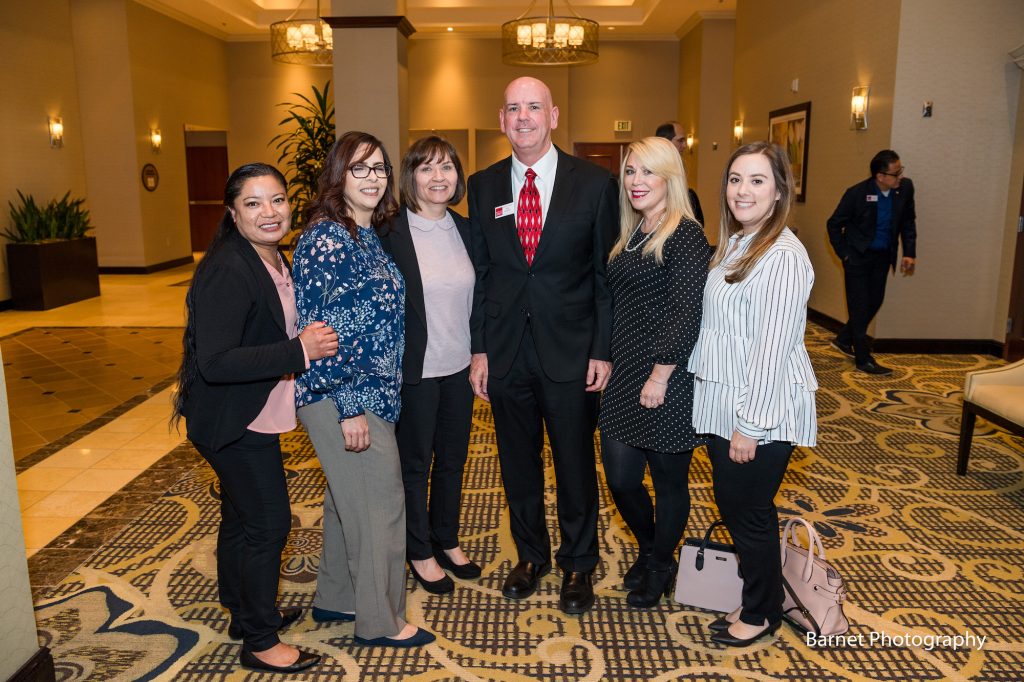Goodwill of Orange County Business Development Manager poses with several women at Difference Makers event.