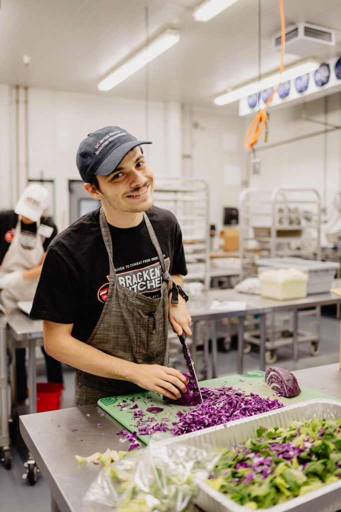 Ethan, posing as he chops vegetables, was selected to be a part of Goodwill of Orange County’s Project SEARCH program