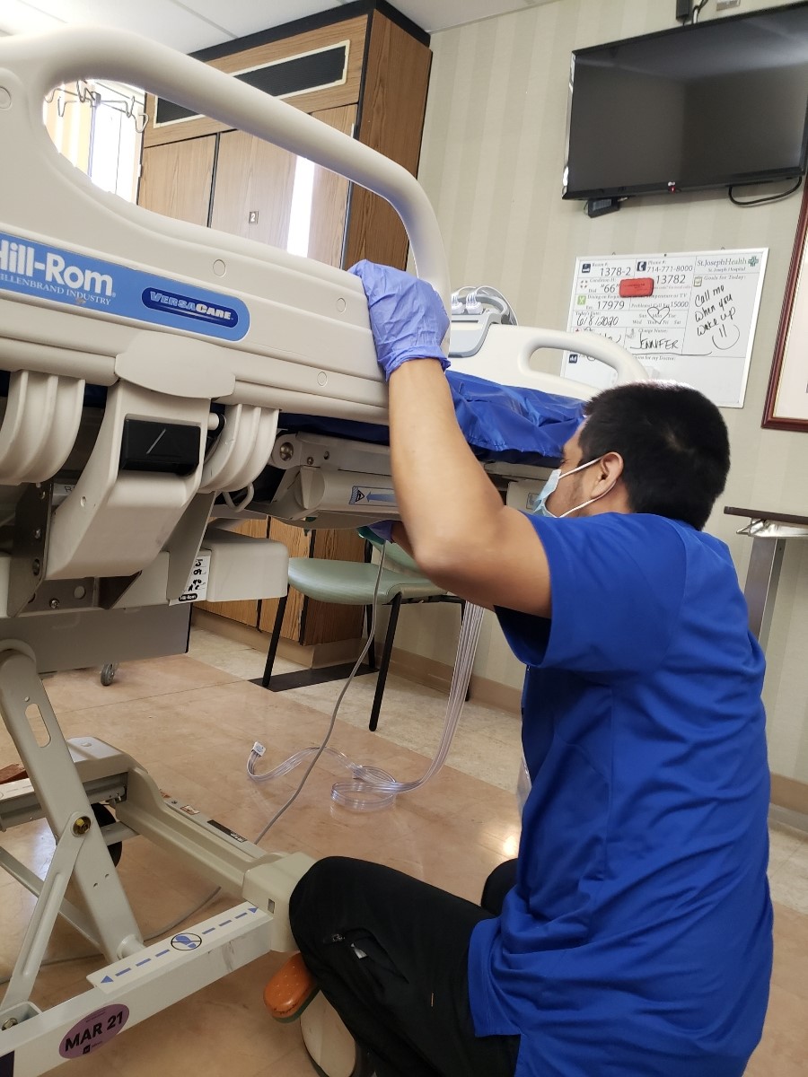 Team member Rogelio focuses on cleaning the rooms and getting them ready for the next patient