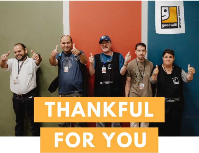 Five people with smiling and posing with their thumbs up